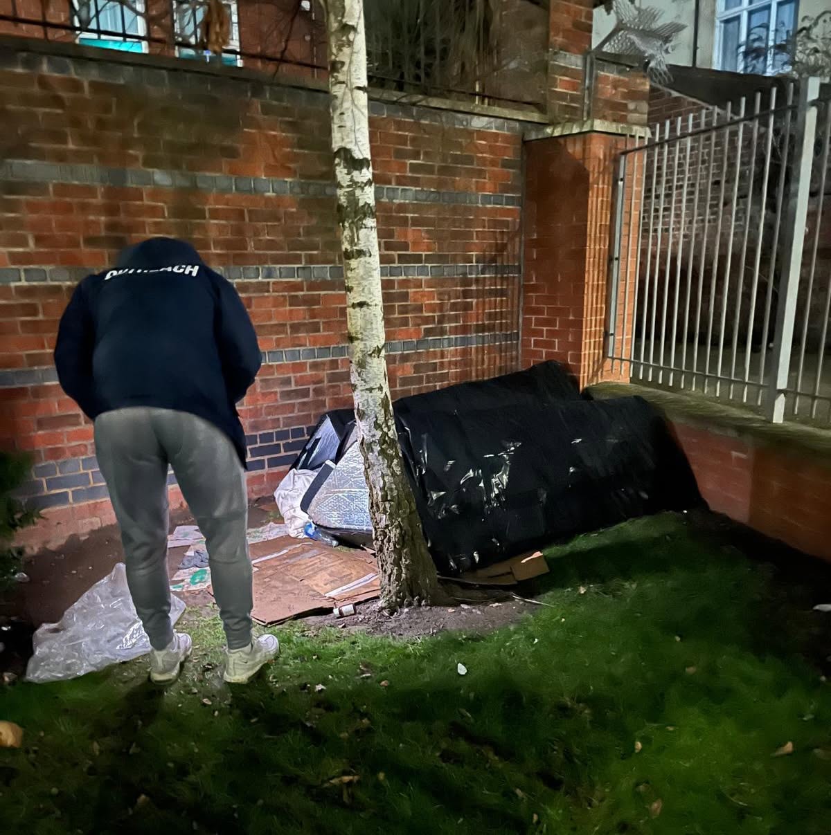 A support worker talking with someone in a doorway